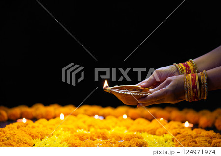 Clay diya lamps lit during diwali celebration, Diwali, or Dipawali, is India's biggest and most important holiday. 124971974