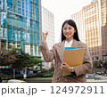 ビルの前でガッツポーズをする若い女性 124972911