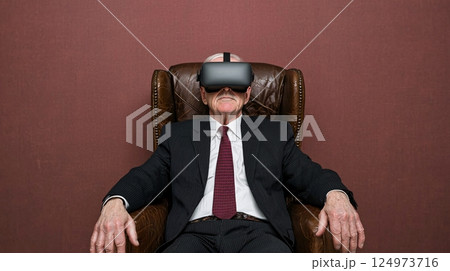 Senior Man Experiencing Virtual Reality Technology in a Comfortable Armchair 124973716