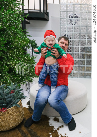 Dad and daughter fooling around near the Christmas tree 124974610