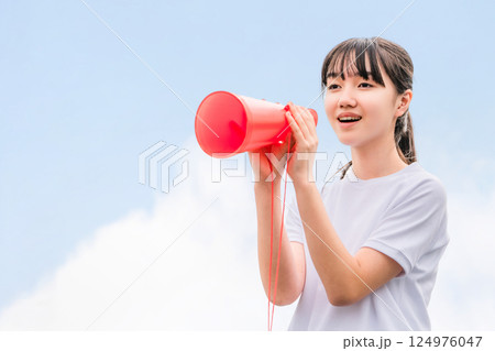 メガホンを持って応援する体操着姿の中学生,高校生,小学生の女の子 124976047
