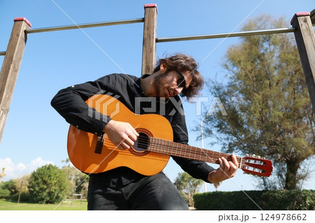Young Man Classic Guitar Player Having Fun In The Park Outside 124978662