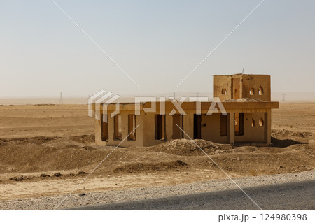 Abandoned building in the Afghan desert landscape under a clear sky 124980398