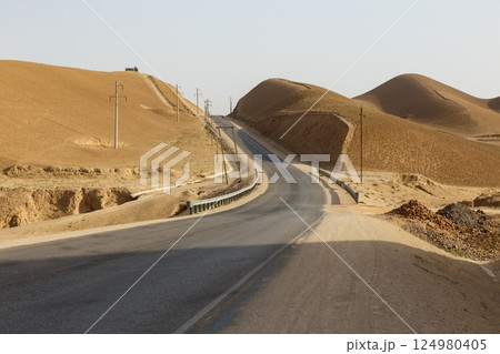 Endless road through the arid landscape of Faryab Province in Afghanistan 124980405