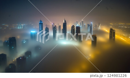 Skyscrapers Emerging Through Dense Fog at Night with City Lights 124981226