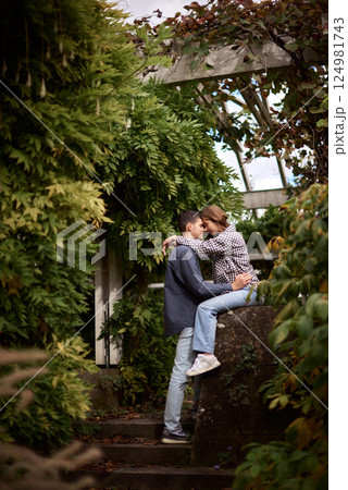 Young Cute Female Hugs Boyfriend. In Autumn Outdoor. Lovers Walking in Park. Attractive Funny Couple. Lovestory in Forest. Man and Woman. Cute Lovers in the Park. Family Concept. Happy Couple. 124981743