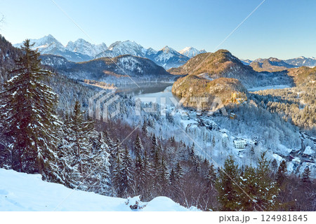 Breathtaking Snowy Mountain Landscape with Lake Near Neuschwanstein Castle in Germany at Dawn Breathtaking Snowy Mountain Landscape with Lake Near Neuschwanstein Castle in Germany at Dawn 124981845