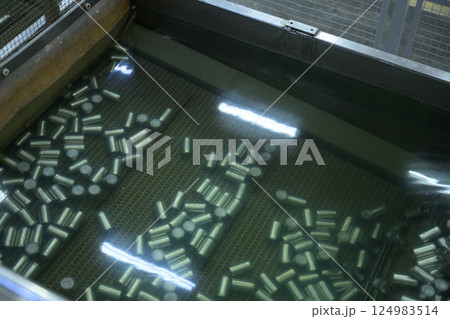 Metal cans submerged in water during the cleaning or sterilization stage in seafood factory Metal cans submerged in water during the cleaning or sterilization stage in seafood factory 124983514