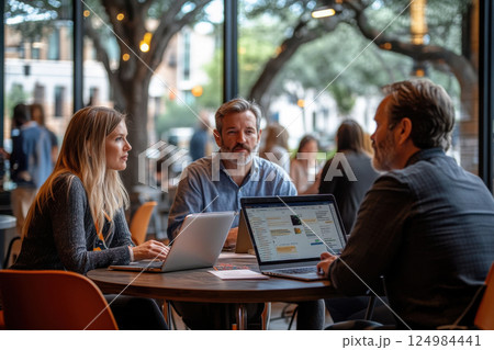 Business meeting coffee shop team collaboration urban setting close-up professional interaction 124984441