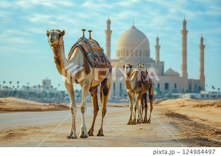 Wide angle photography of camel caravan journey by majestic mosque in desert landscape Wide angle photography of camel caravan journey by majestic mosque in desert landscape 124984497