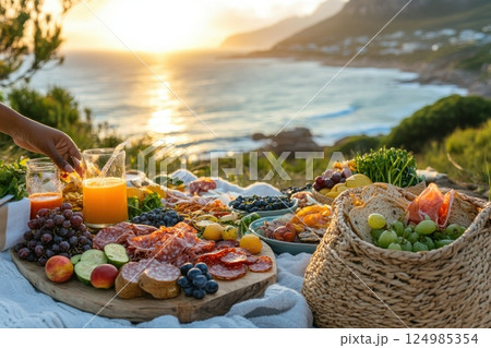 Sunset picnic feast by the ocean culinary experience scenic nature relaxing viewpoint 124985354