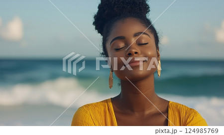 Peaceful woman enjoying tranquility by the ocean under a clear sky with soft waves  124985769