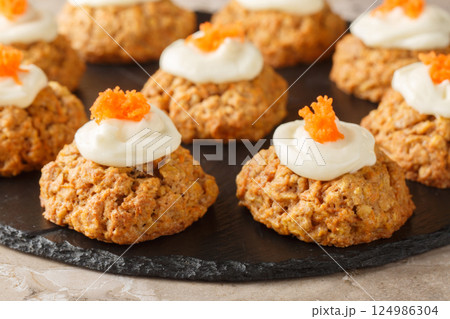 Healthy Carrot Oatmeal Cookies with Cheese Frosting Close-up on Plate. Horizontal 124986304