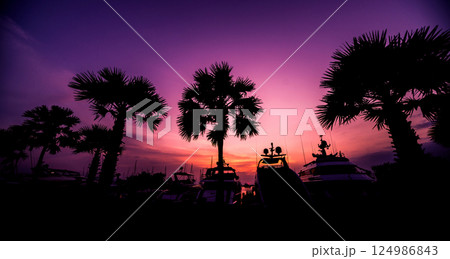 Beautiful sunset sky in the marina bay. View of harbor with yachts Beautiful sunset sky in the marina bay. View of harbor with yachts 124986843