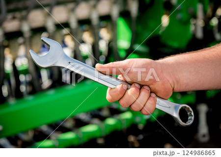The mechanics repair combine harvester. Modern agricultural machinery The mechanics repair combine harvester. Modern agricultural machinery 124986865