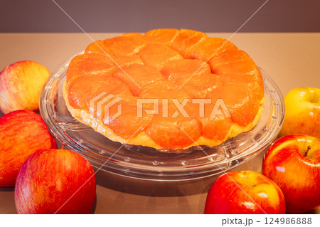 Golden crusted apple Tarte Tatin with glistening fruit topping photographed in retro magazine style Golden crusted apple Tarte Tatin with glistening fruit topping photographed in retro magazine style 124986888