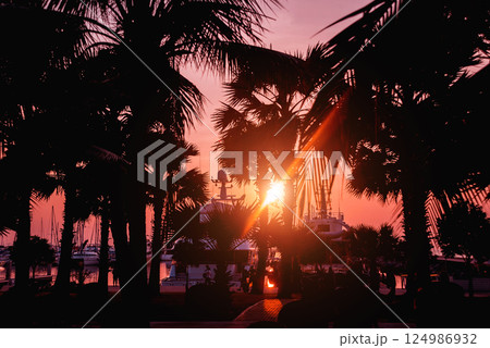 Beautiful sunset sky in the marina bay. View of harbor with yachts Beautiful sunset sky in the marina bay. View of harbor with yachts 124986932