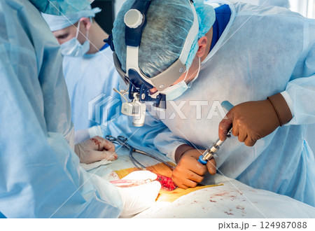 Spinal surgery. Group of surgeons in operating room with surgery equipment. Spinal surgery. Group of surgeons in operating room with surgery equipment. 124987088