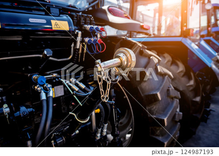 Rear view of modern agricultural tractor. Industrial details. 124987193