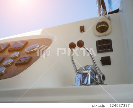 Close up of a steering wheel located on a sailing boat 124987357