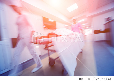 Nurses moves medical stretcher with patient at hospital. Medical equipment. Nurses moves medical stretcher with patient at hospital. Medical equipment. 124987458