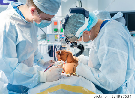Spinal surgery. Group of surgeons in operating room with surgery equipment. Spinal surgery. Group of surgeons in operating room with surgery equipment. 124987534