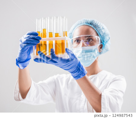 Scientist pouring organic oil. Beauty and cosmetics sciences.  124987543