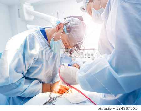Spinal surgery. Group of surgeons in operating room with surgery equipment. Spinal surgery. Group of surgeons in operating room with surgery equipment. 124987563