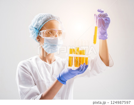 Scientist pouring organic oil. Beauty and cosmetics sciences.  124987597