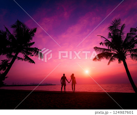 Silhouette of couple on tropical beach during sunset  124987601