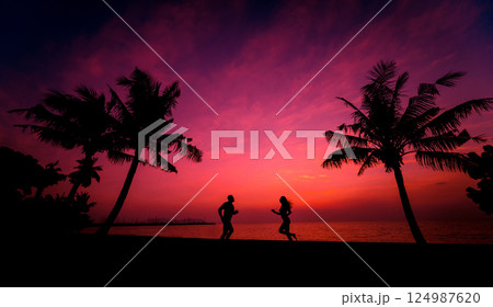 Silhouette of couple on tropical beach during sunset on background Silhouette of couple on tropical beach during sunset on background 124987620
