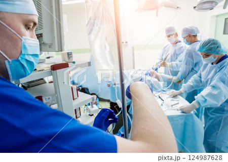 Arthroscope surgery. Orthopedic surgeons in teamwork in the operating room 124987628