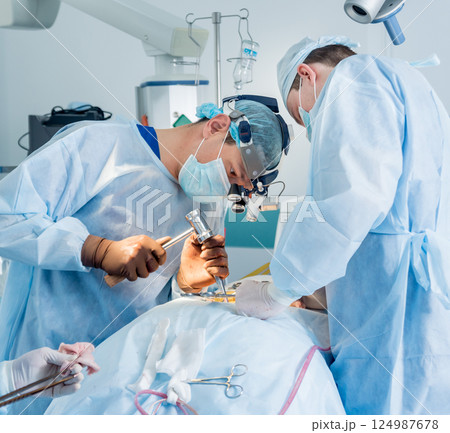 Spinal surgery. Group of surgeons in operating room with surgery equipment. Spinal surgery. Group of surgeons in operating room with surgery equipment. 124987678