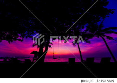 Beautiful tropical beach with palm trees. Sunrises and sunsets. Ocean. 124987889