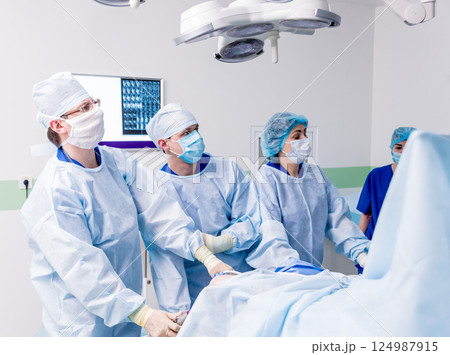 Arthroscope surgery. Orthopedic surgeons in teamwork in the operating room Arthroscope surgery. Orthopedic surgeons in teamwork in the operating room 124987915