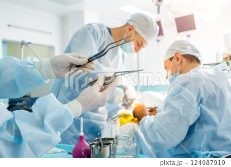 Brain surgery. Group of surgeons in operating room with surgery equipment. Brain surgery. Group of surgeons in operating room with surgery equipment. 124987919