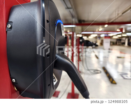 Modern EV charging station in a well lit parking showing all available spots for user convenience. 124988105