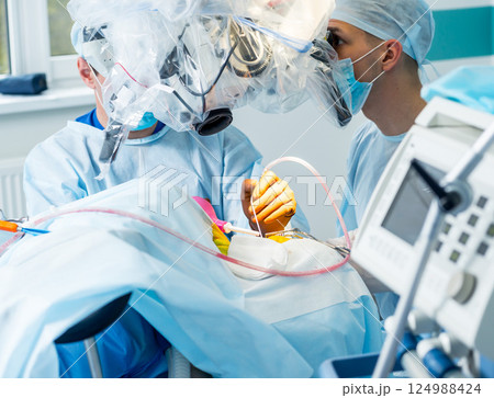 Brain surgery. Group of surgeons in operating room with surgery equipment. 124988424