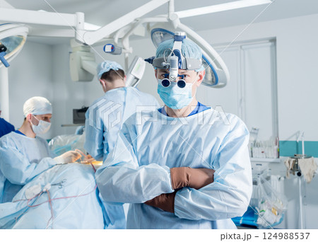 Spinal surgeon in operating room with surgery equipment. Spinal surgeon in operating room with surgery equipment. 124988537