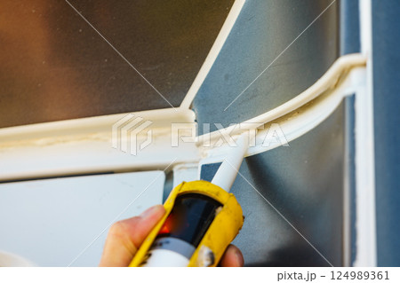 Applying silicon on caravan body Applying silicon on caravan body 124989361