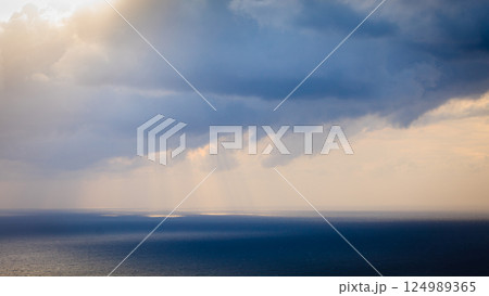 Dark storm rainy clouds on sea 124989365