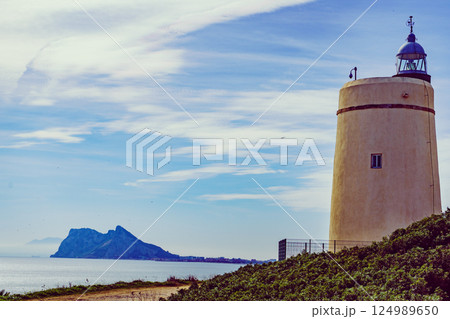 Lighthouse and Gibraltar rock, La Alcaidesa, Spain. 124989650