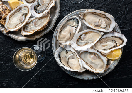 Fresh raw oysters on ice, overhead flat lay shot Fresh raw oysters on ice, overhead flat lay shot 124989888