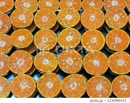 Fresh oranges halved and arranged in a row. Fresh oranges halved and arranged in a row. 124990431