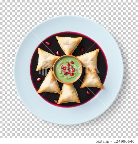 Samosa Chaat - Crushed golden samosas topped with tangy tamarind sauce, spicy mint chutney, yogurt, sev, and pomegranate seeds. 124990640