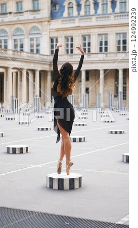 Minimalist Ballet Pose on Pointe in Historic Paris Courtyard with Soft Light 124992239