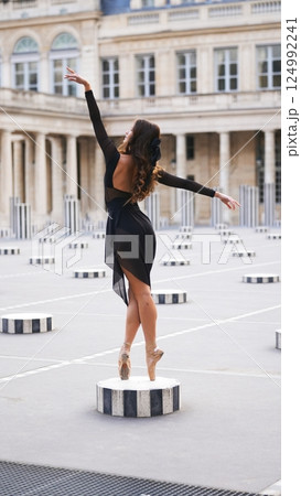 Graceful Ballerina on Pointe in Paris Courtyard by Elegant Architecture 124992241