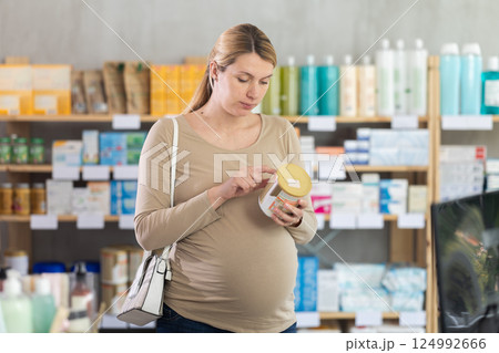 Pregnant woman chooses baby formula at pharmacy 124992666