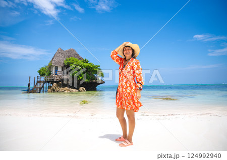 Woman enjoys vacation in Zanzibar, experiencing its beauty 124992940