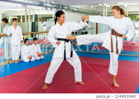 Girl sparring with karate trainer 124993040